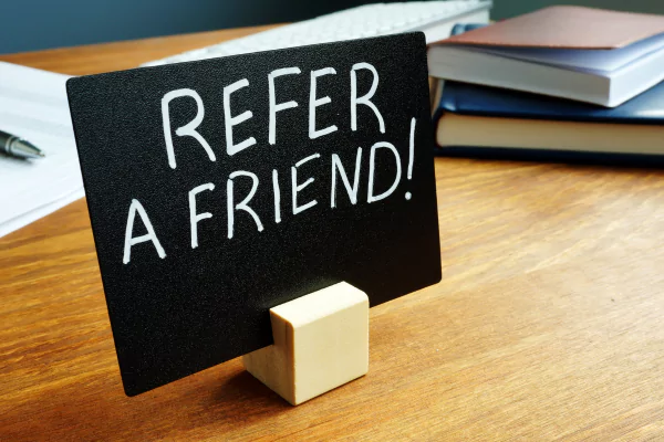 A sign showing refer a friend