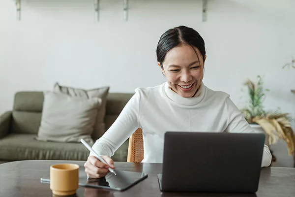 A woman smiling and a laptop